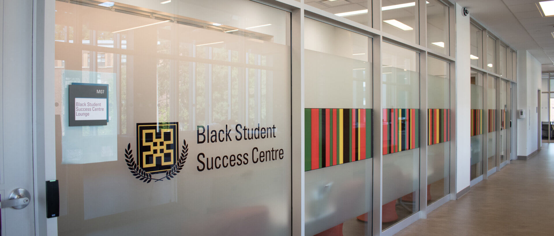 The Black Student Success Centre logo and text on the decorated wall in front of the BSSC lounge.