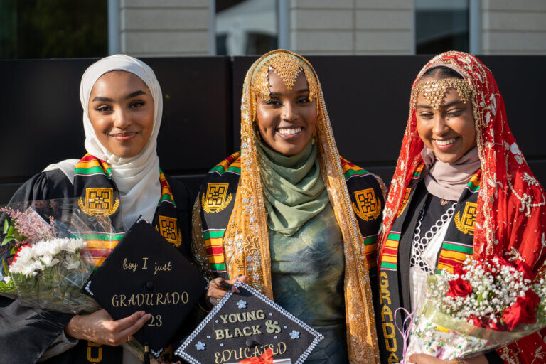 3 female black graduates smiling