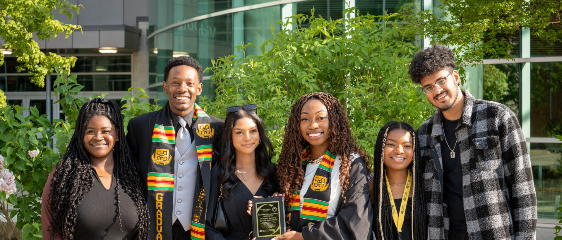 A group of black students posing after graduation