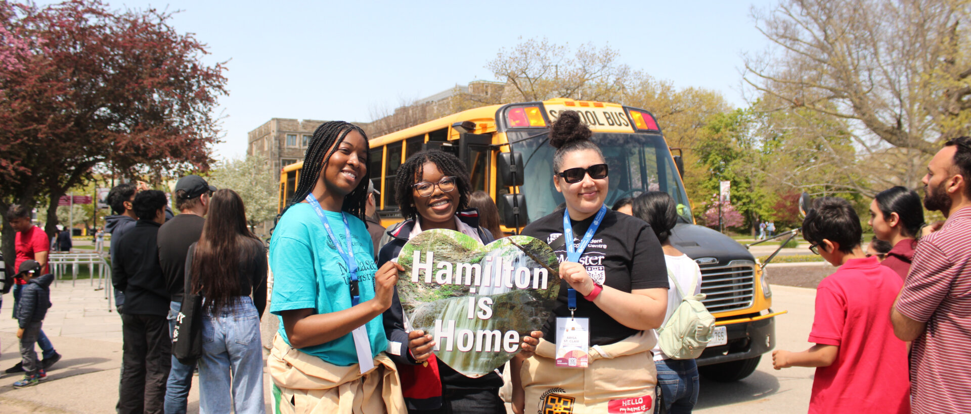 Three people smiling, holding a
