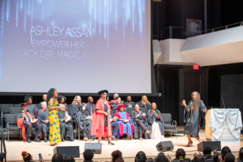 An image of a student dancing across stage to receive an award during the Black Graduation Celebration