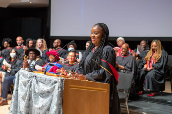An image of Faith Ogunkoya giving a speech during the Black Graduation Celebration 2022