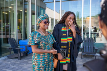An image of a graduate and her mother smiling at the Black Graduation Celebration.