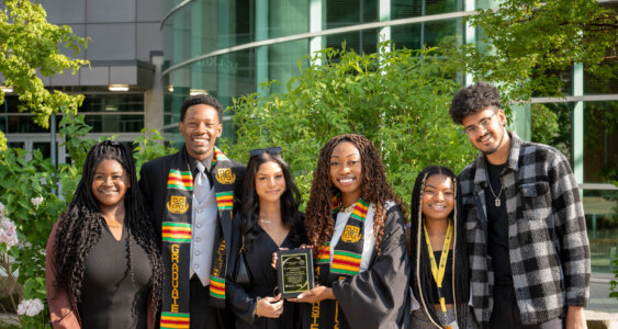 A group of black students posing after graduation